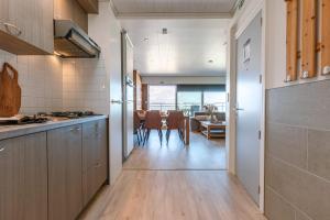 a kitchen with wooden floors and a dining room at Magnificent Apartment with Great Panoramic Seaview in De Haan