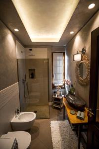 a bathroom with a sink and a toilet and a shower at L'antica Fornace di Barale Emanuela in Vicoforte