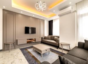 a living room with a couch and a tv at Selia SUİTES in Trabzon
