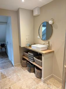 a bathroom with a sink and a mirror at La maison du tripot in Honfleur