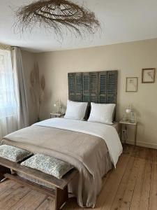 a bedroom with a large bed with a wooden floor at La maison du tripot in Honfleur