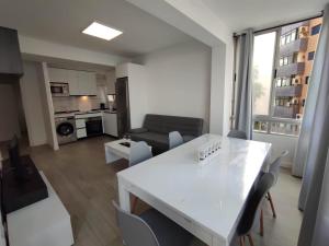a kitchen and living room with a white table and chairs at apartamento vacacional in Calpe