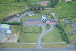 an aerial view of a farm with a police station at Norfolk Motel & Campervan Park in Awanui