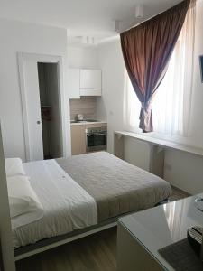 a small bedroom with a bed and a window at Romantic Room in Monopoli