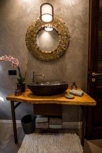 a bathroom with a sink and a mirror on the wall at L'antica Fornace di Barale Emanuela in Vicoforte