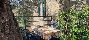 a table with a table cloth on it next to a tree at Antica casa vista mare in Pompeiana