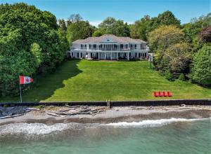 an aerial view of a large house on the water at Somerset - A Private Retreat in Niagara on the Lake