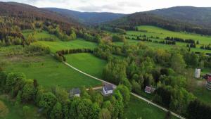 an aerial view of a green field with a house at Helenowa Polana in Stary Gieraltow