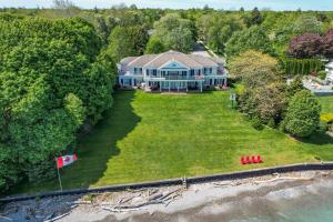 an aerial view of a large house with a flag at Somerset - A Private Retreat in Niagara-on-the-Lake