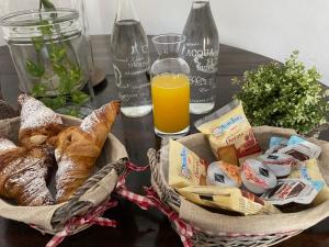 a table with a basket of bread and orange juice at Donna Elena in Vico del Gargano