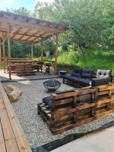 a patio with a fire pit and a wooden pavilion at Casa Daria 