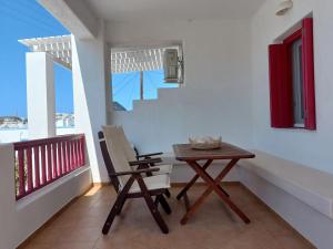 ein Zimmer mit einem Tisch und einem Stuhl auf einem Balkon in der Unterkunft Solid Residence in Triovasálos