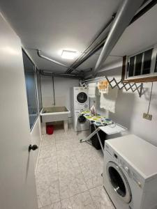 a laundry room with a washer and dryer at Villa overlooking Cies Islands in Vigo