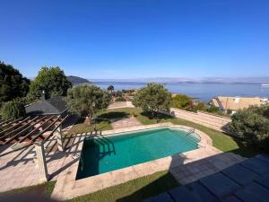 a swimming pool with a view of the ocean at Villa overlooking Cies Islands in Vigo