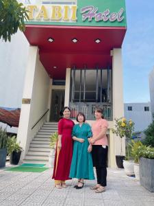 three women standing in front of a hotel at Tabii hotel in Da Nang