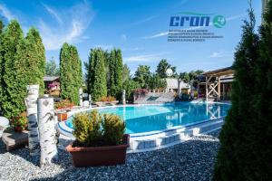 a swimming pool in a garden with trees at B&B Obermair in Brunico