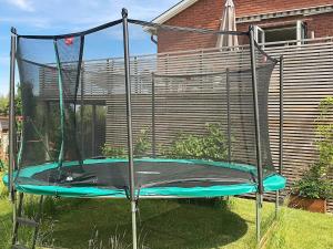 an empty trampoline in the yard of a house at 5 person holiday home in BANKERYD in Bankeryd
