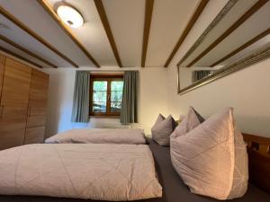 a bedroom with two beds and a mirror at Pia's Nature Retreat in Neukirch