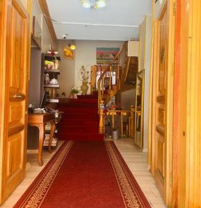 a hallway with a red carpet and a staircase with a red rug at Old City Family Hotel in Istanbul