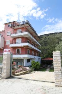 a pink building with a sign in front of it at Villa Deart Berat in Berat