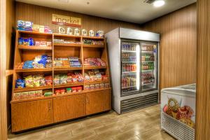 a grocery store aisle with a refrigerator and food at Fairfield Inn & Suites by Marriott Edmond in Edmond