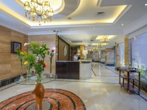 a lobby of a hotel with flowers on the floor at Boudl Kuwait Al Fahahil in Kuwait