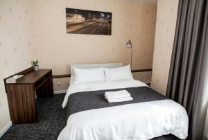 Postel nebo postele na pokoji v ubytování Hotel Tomas