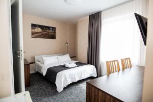 Postel nebo postele na pokoji v ubytování Hotel Tomas