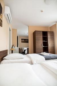 Postel nebo postele na pokoji v ubytování Hotel Tomas