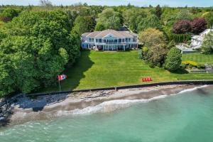 an aerial view of a house next to the water at Somerset - A Private Retreat in Niagara on the Lake