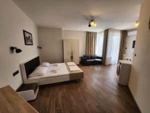 a living room with a bed and a couch in it at Golden Sands Apartments Zlatna Kotva in Golden Sands +85 photos