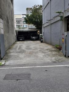 a parking lot with cars parked in a tunnel at Hometown B&B in Hualien City