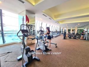 a woman in a gym with cardio machines at M city service suite KLCC in Kuala Lumpur