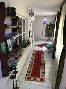 a hallway with a rug on a tile floor at Prenociste Chardak in Tuzla