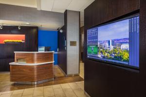 a lobby with a large screen tv in a building at Courtyard by Marriott Riverside UCR/Moreno Valley Area in Riverside