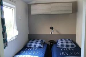a bedroom with two beds and a window at Mobil confort 2 chambres 1 sd 35m2 à la teste in La Teste-de-Buch