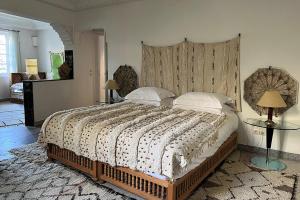 a bedroom with a large bed with a large headboard at Riad Jardin Des Biehn in Fez
