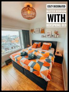 a bedroom with a bed with a large window at CASA MARE hartje Oostende met gratis parking in Ostend