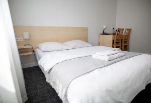 Postel nebo postele na pokoji v ubytování Hotel Tomas
