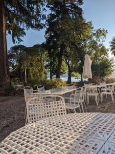 a group of tables and chairs with an umbrella at Verbania Centro Storico 2 camere in Verbania
