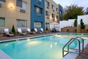 a swimming pool in front of a building at Four Points by Sheraton Melville Long Island in Plainview