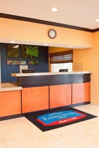 a lobby with a counter with a clock on the wall at Fairfield Inn by Marriott Forsyth Decatur in Forsyth