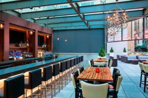 un restaurante con mesa y sillas y un bar en Four Points by Sheraton New York Downtown, en Nueva York