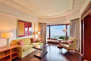a living room with a couch and two chairs at Hyderabad Marriott Hotel & Convention Centre in Hyderabad
