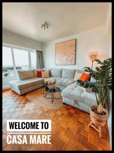 a living room with a couch and a table at CASA MARE hartje Oostende met gratis parking in Ostend