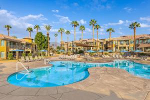 a swimming pool at a resort with palm trees at Marriott's Desert Springs Villas II in Palm Desert