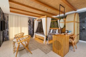 a bedroom with a bed and a table and a desk at Afflon Hotels Sea Hill Concept in Antalya