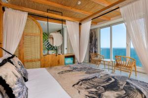 a bedroom with a bed with a view of the ocean at Afflon Hotels Sea Hill Concept in Antalya