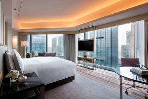 a bedroom with a large bed and a large window at JW Marriott Hotel Chengdu in Chengdu
