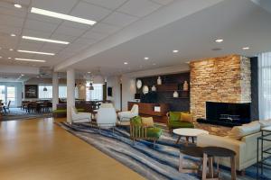 a lobby of a hospital with chairs and a fireplace at Fairfield Inn & Suites by Marriott Columbus Airport in Columbus